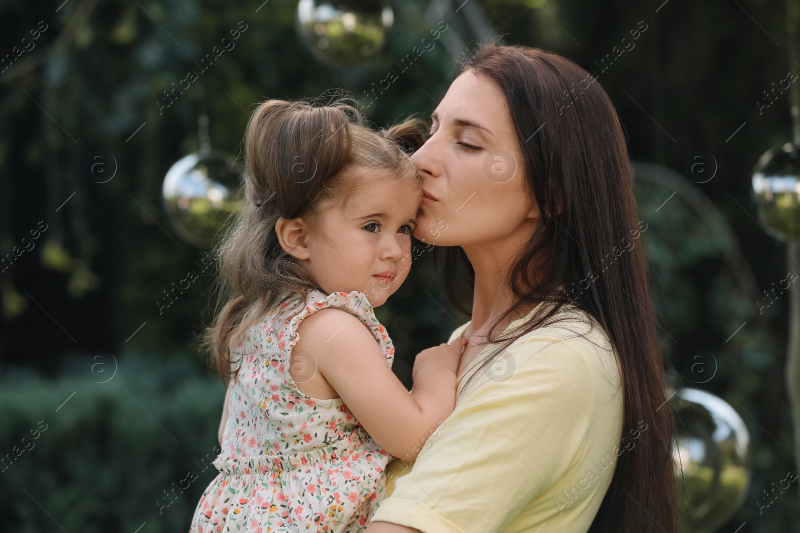 Photo of Portrait of mother with her cute daughter in park
