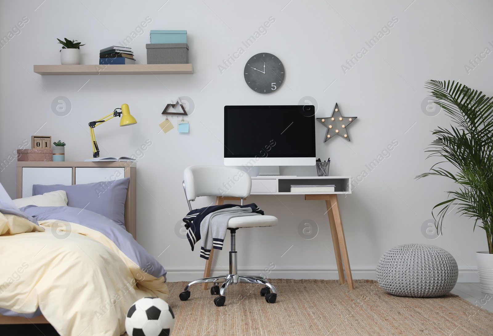 Photo of Stylish teenager's room interior with comfortable bed and workplace