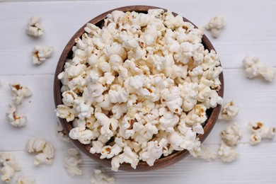 Tasty popcorn on white wooden table, flat lay