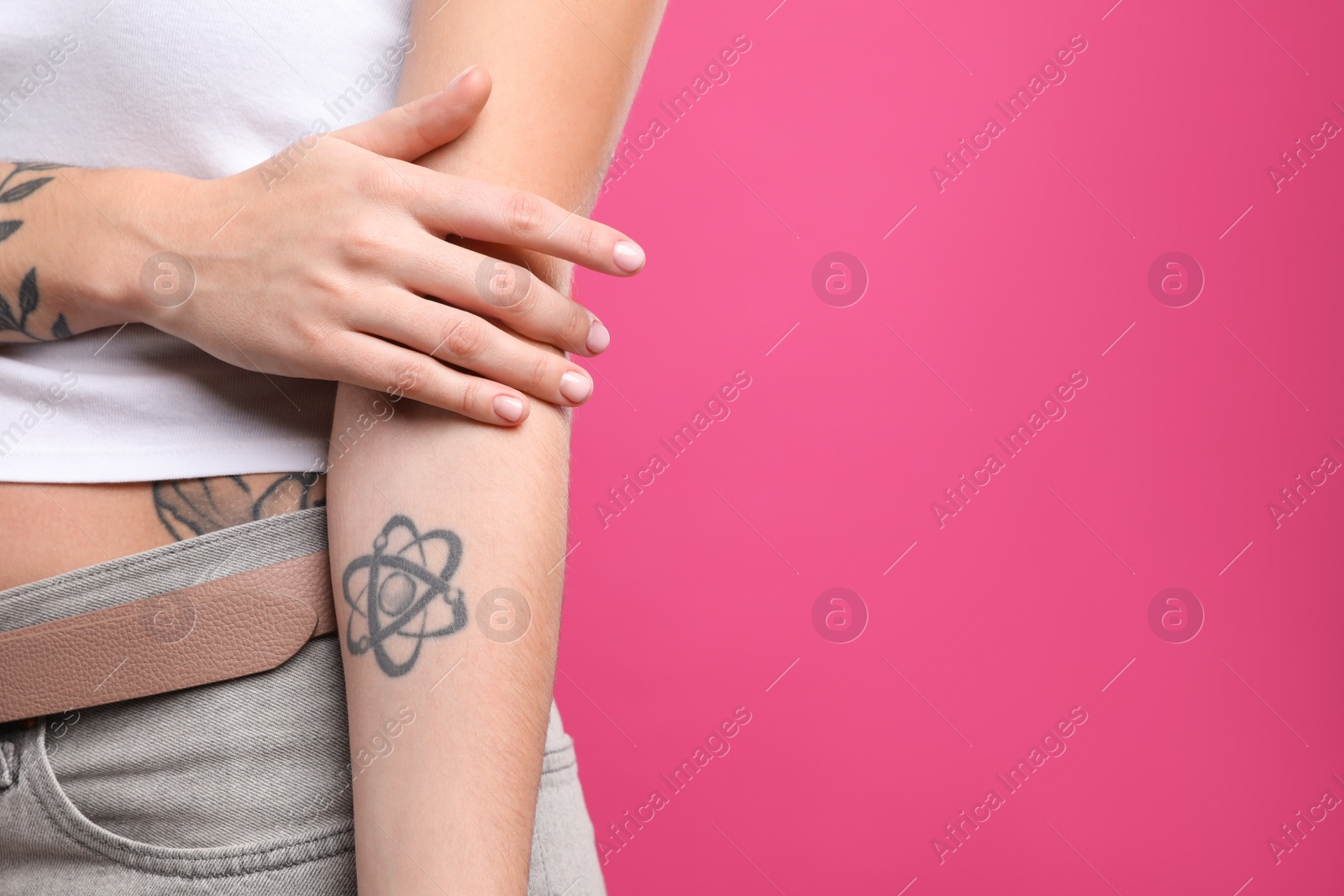 Photo of Woman with tattoos on body against pink background, closeup. Space for text