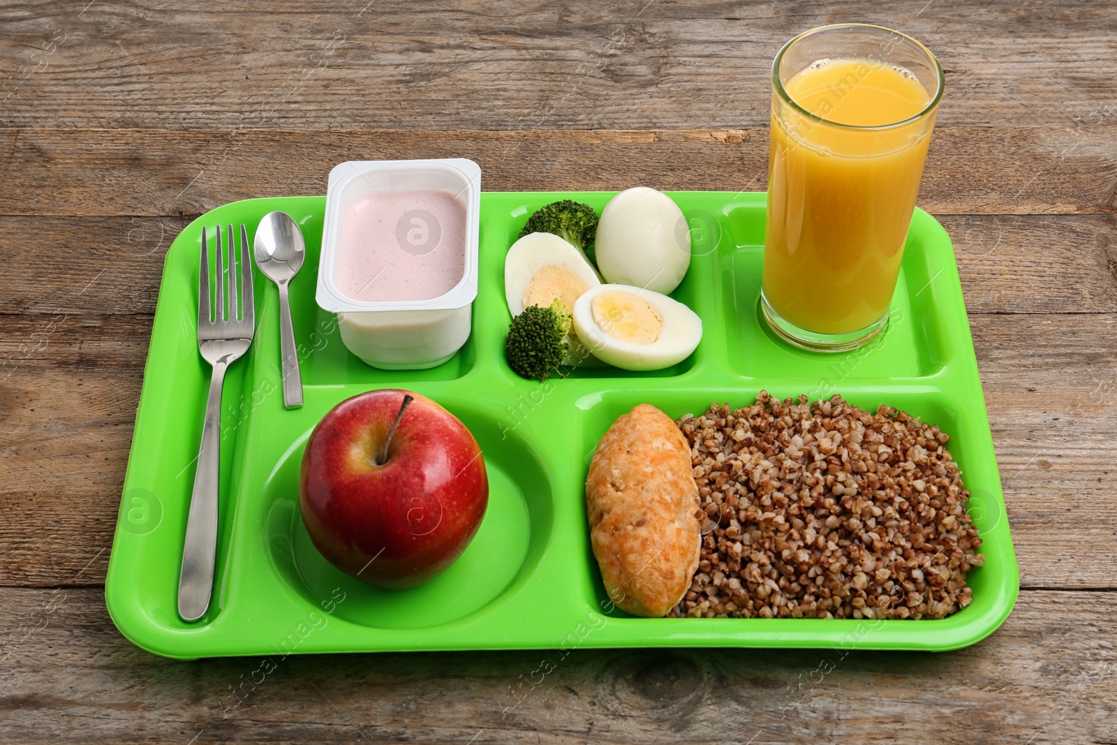Photo of Serving tray with healthy food on wooden background. School lunch