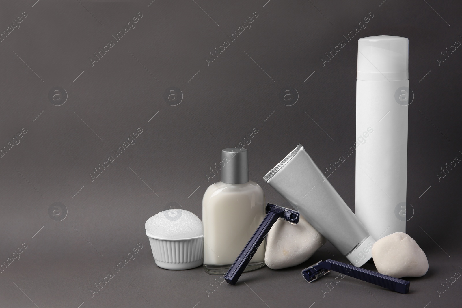 Photo of Different men's shaving accessories on dark grey background. Space for text