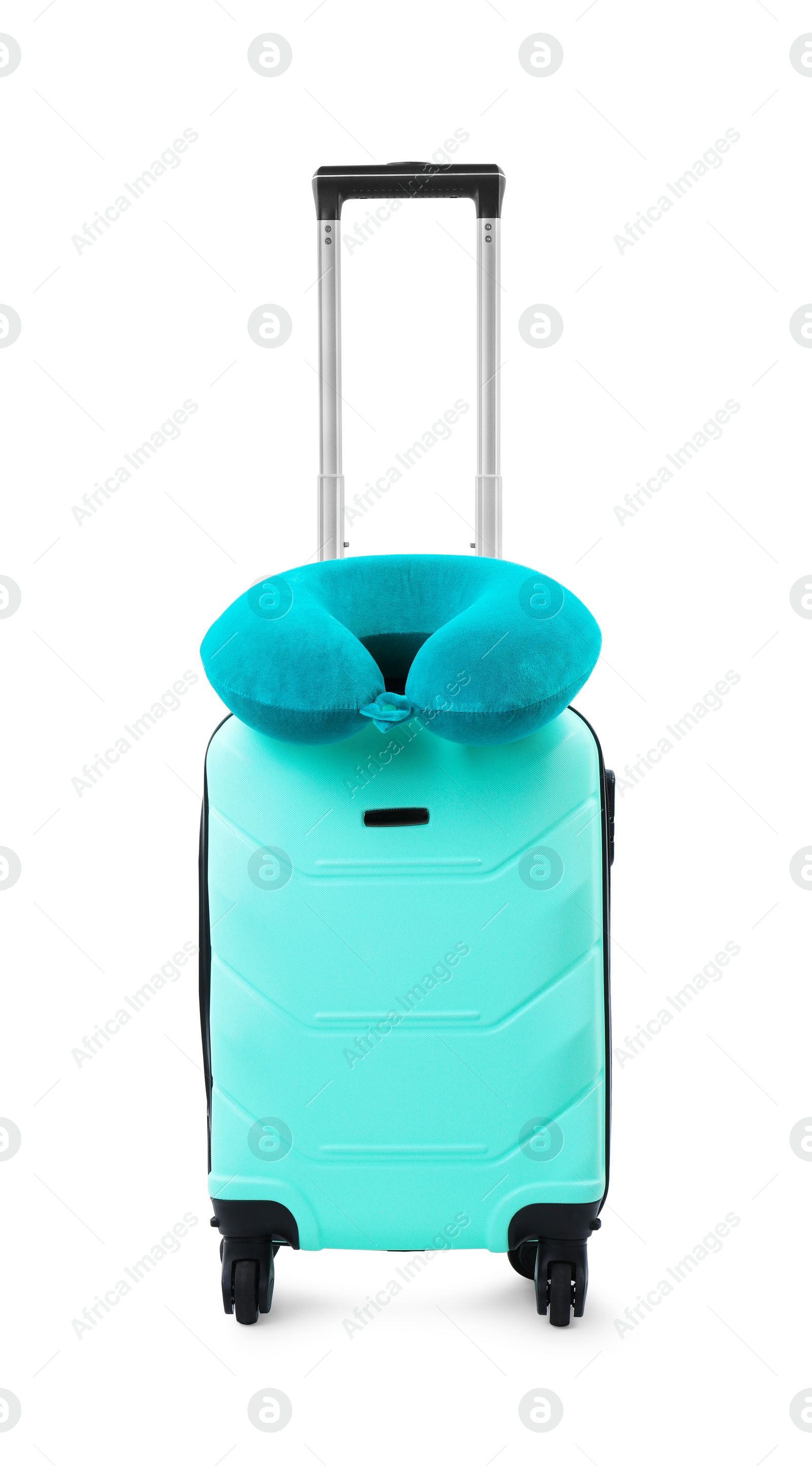 Photo of Soft travel pillow on turquoise suitcase isolated on white