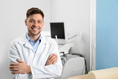 Photo of Professional sonographer near modern ultrasound machine in clinic