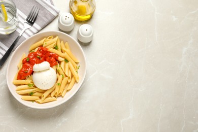 Photo of Delicious pasta with burrata cheese and sauce served on light grey table, flat lay. Space for text