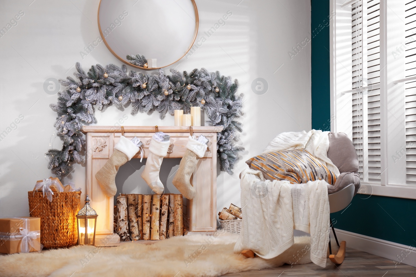 Photo of Fireplace with Christmas stockings in festive room interior