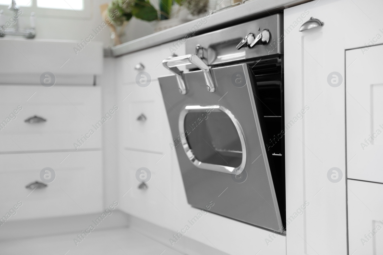 Photo of New modern oven in stylish kitchen. Cooking appliance