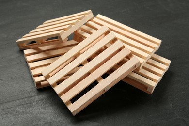 Pile of wooden pallets on black table