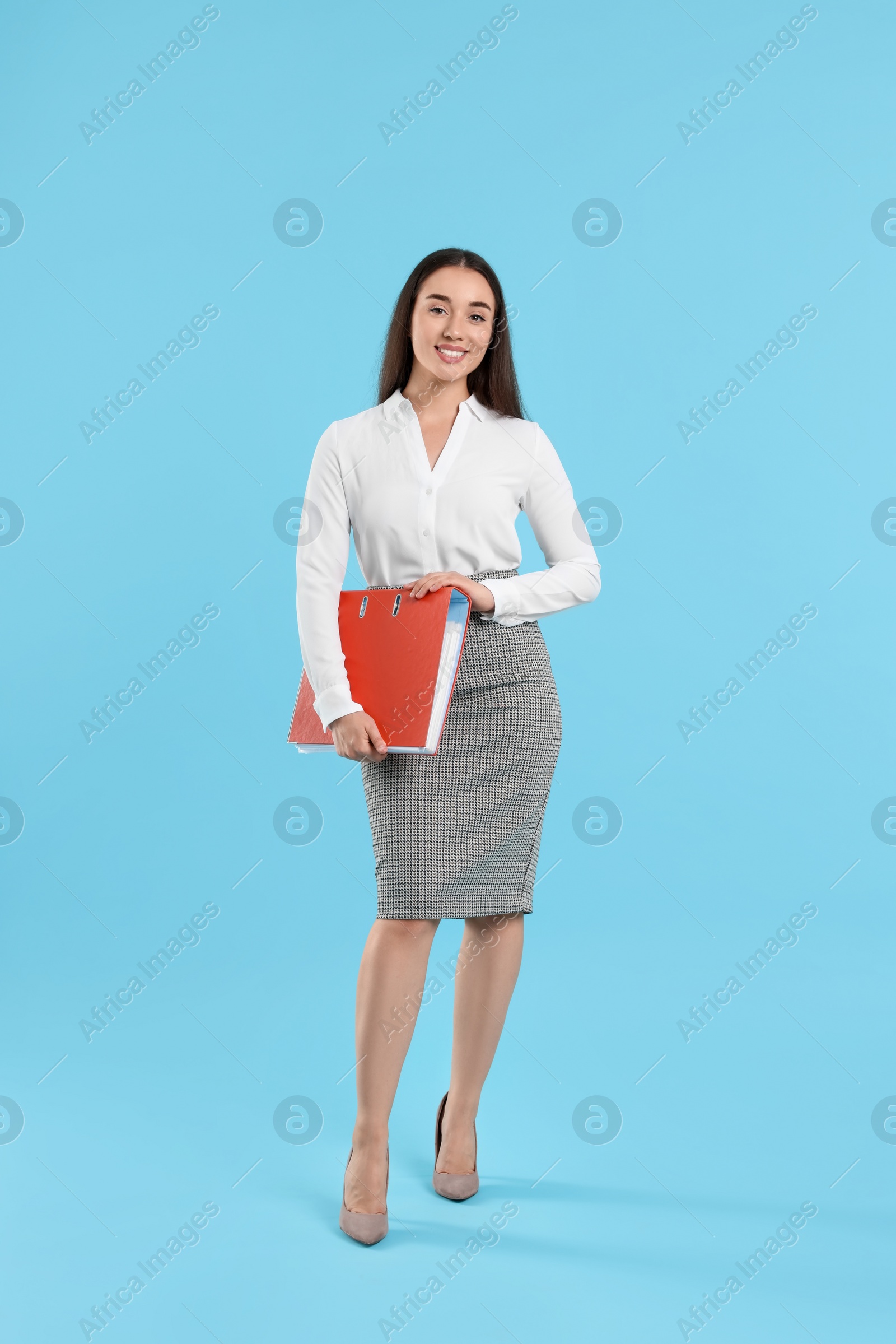 Photo of Happy woman with folder on light blue background