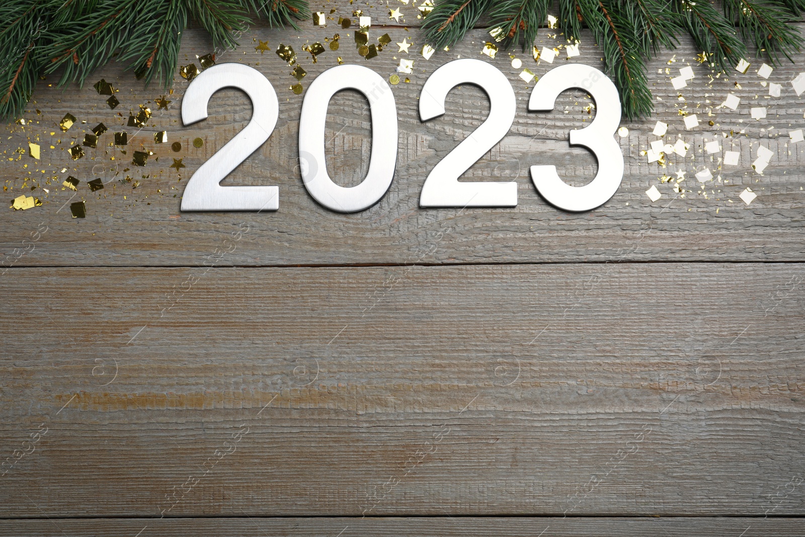 Photo of Flat lay composition with number 2023 and festive decor on wooden background, space for text. Happy New Year