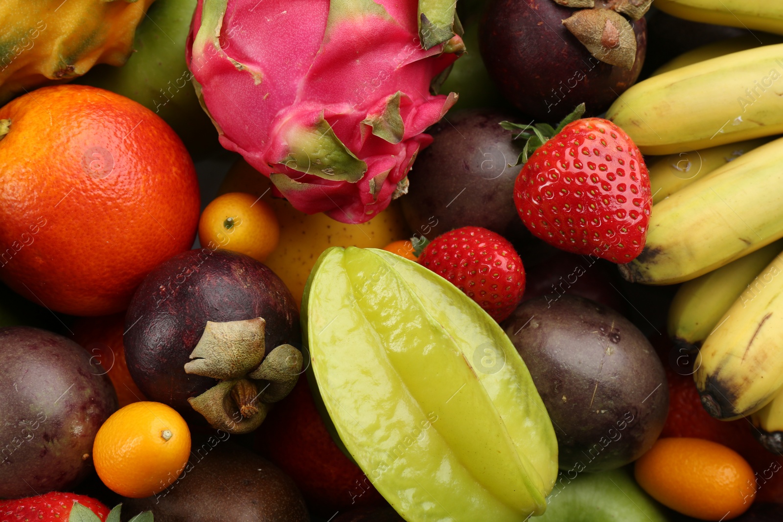 Photo of Assortment of fresh exotic fruits as background, top view