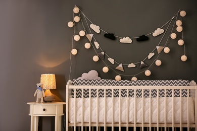 Baby bedroom interior with crib and beautiful decor elements