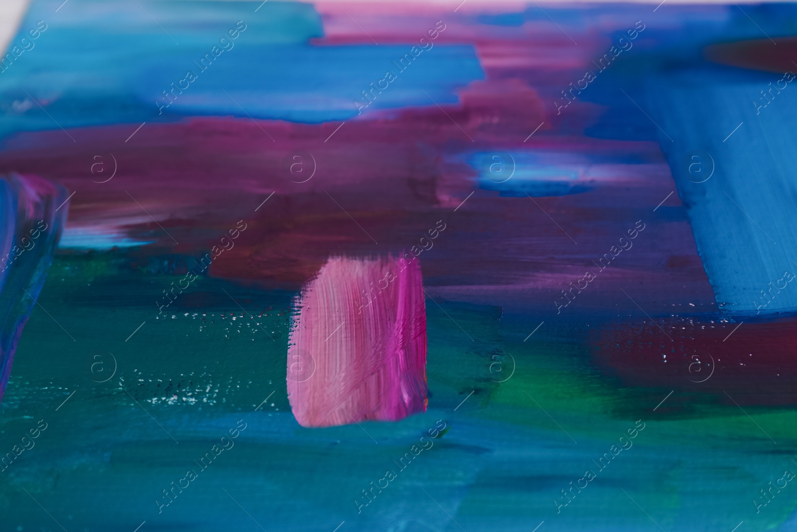 Photo of Canvas with colorful abstract painting, closeup view