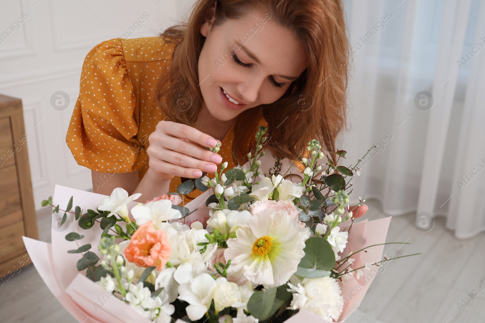 Photo of Beautiful woman with bouquet of flowers indoors