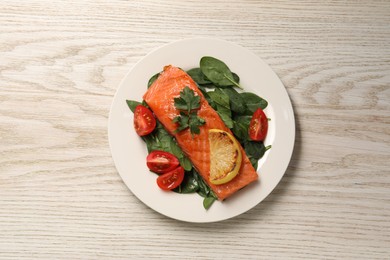 Photo of Tasty grilled salmon with tomatoes, lemon and basil on white wooden table, top view