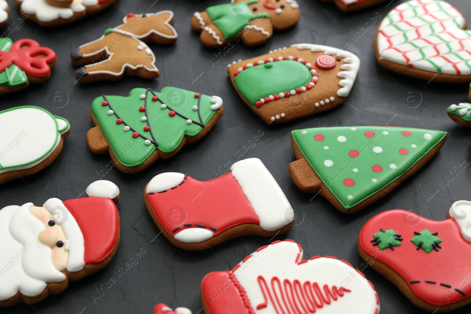 Photo of Many different delicious Christmas cookies on black table