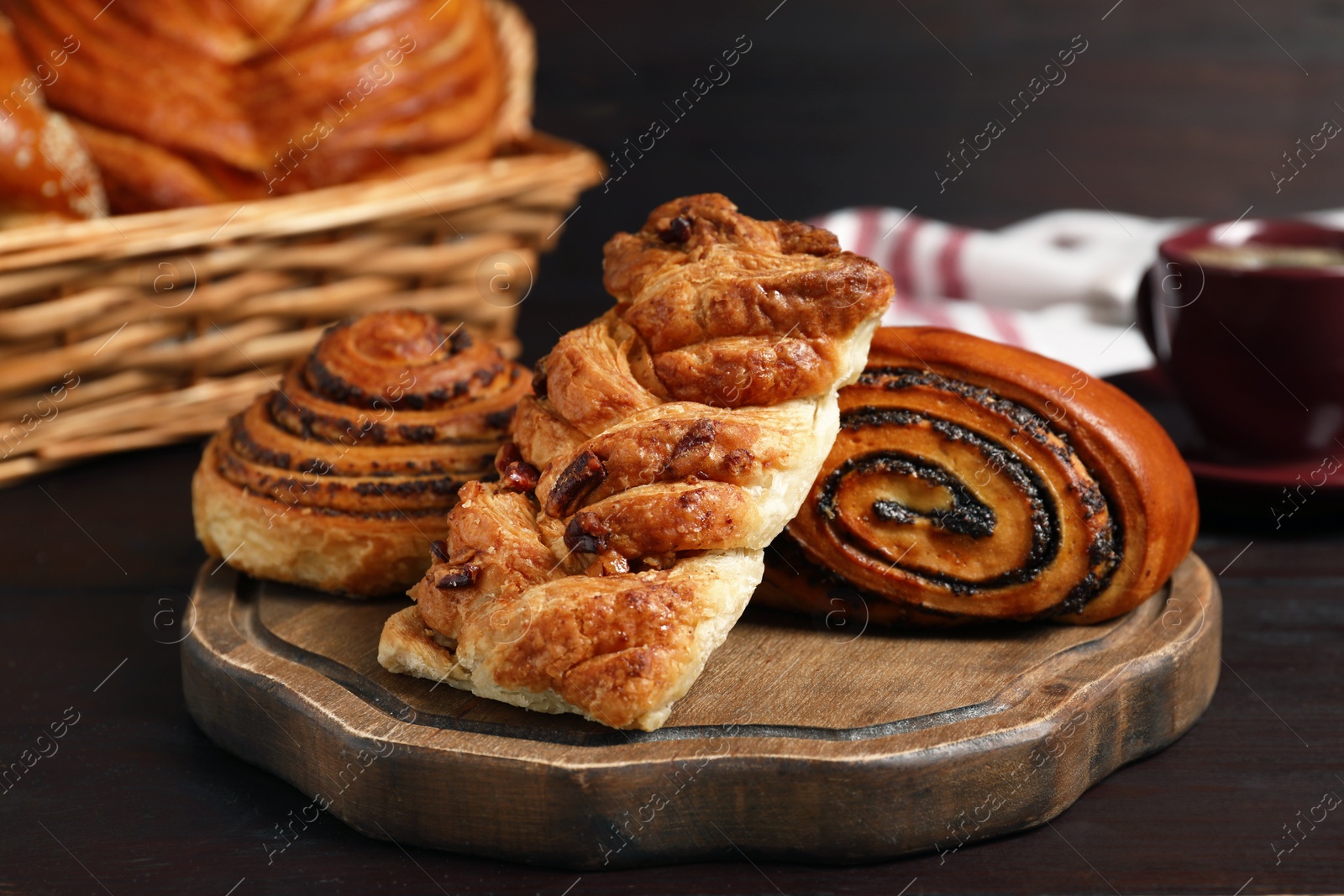 Photo of Different tasty freshly baked pastries on wooden table