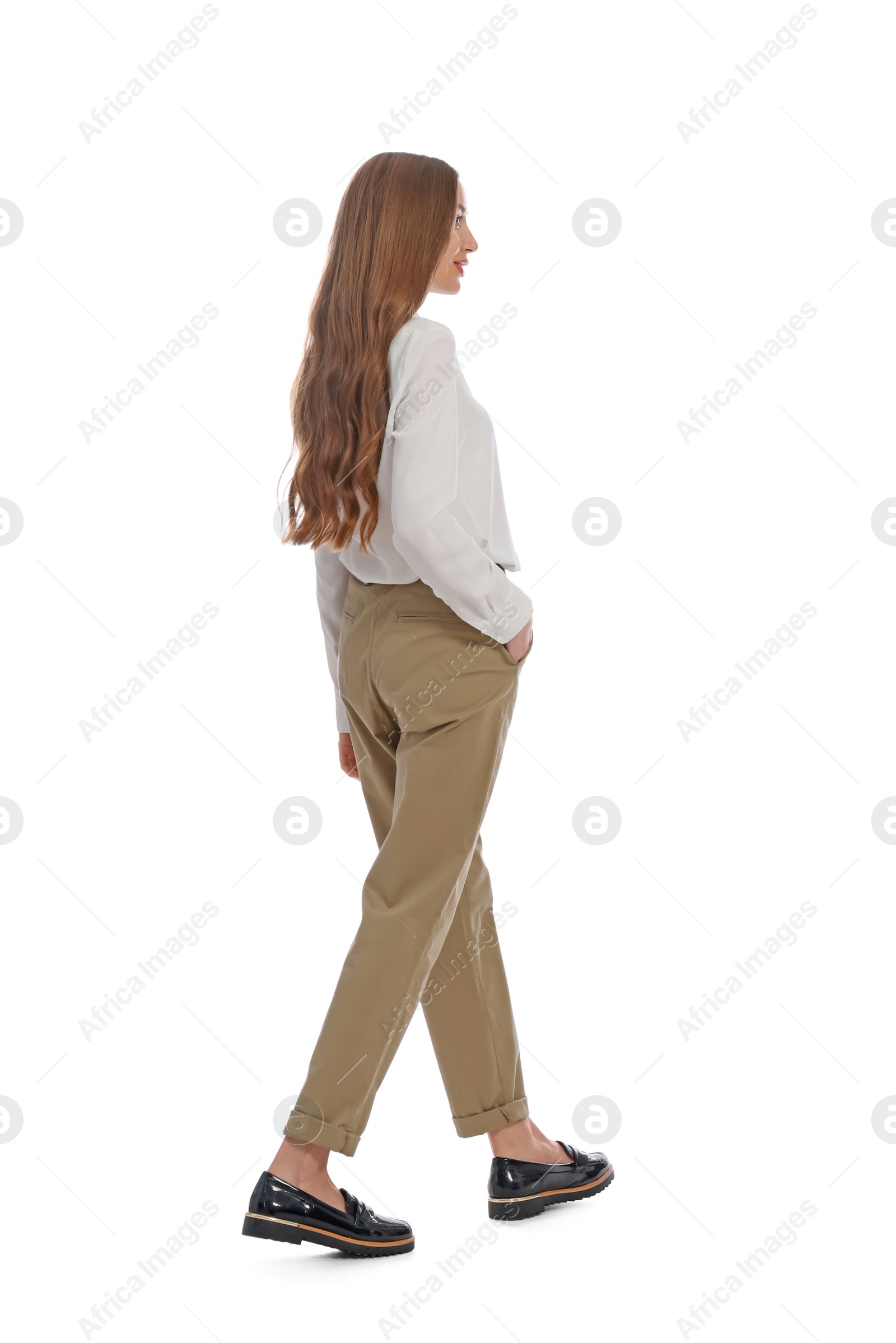 Photo of Young woman in casual outfit walking on white background