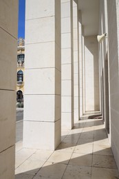 Photo of View of modern beige building with columns outdoors