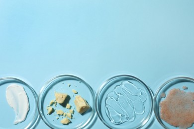 Photo of Many petri dishes with samples on light blue background, flat lay. Space for text