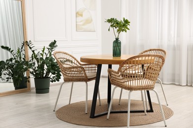 Photo of Dining room interior with comfortable furniture and plants