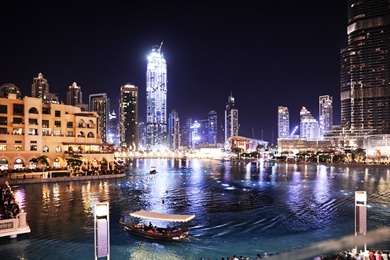 Photo of DUBAI, UNITED ARAB EMIRATES - NOVEMBER 04, 2018: Beautiful night cityscape with Burj Khalifa lake at Downtown Dubai