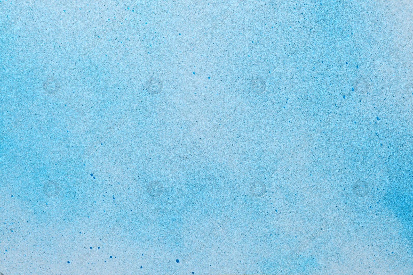 Photo of Canvas covered with light blue spray paint as background