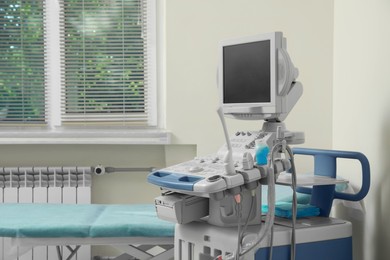 Photo of Ultrasound machine and examination table in hospital