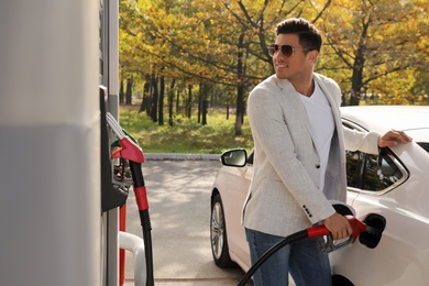 Photo of Man refueling car at self service gas station