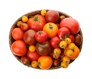 Fresh ripe tomatoes in wicker bowl on white background, top view