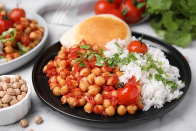 Photo of Plate with delicious chickpea curry on table, closeup