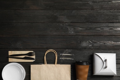 Different containers for mock up design on wooden background, flat lay. Food delivery service