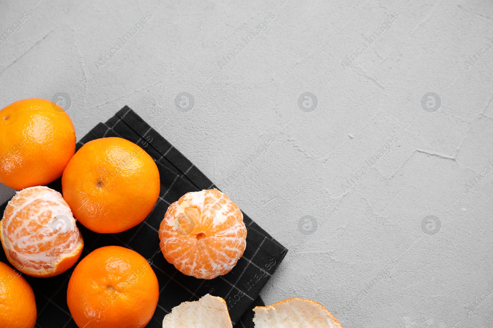 Photo of Fresh ripe tangerines on grey table, flat lay. Space for text
