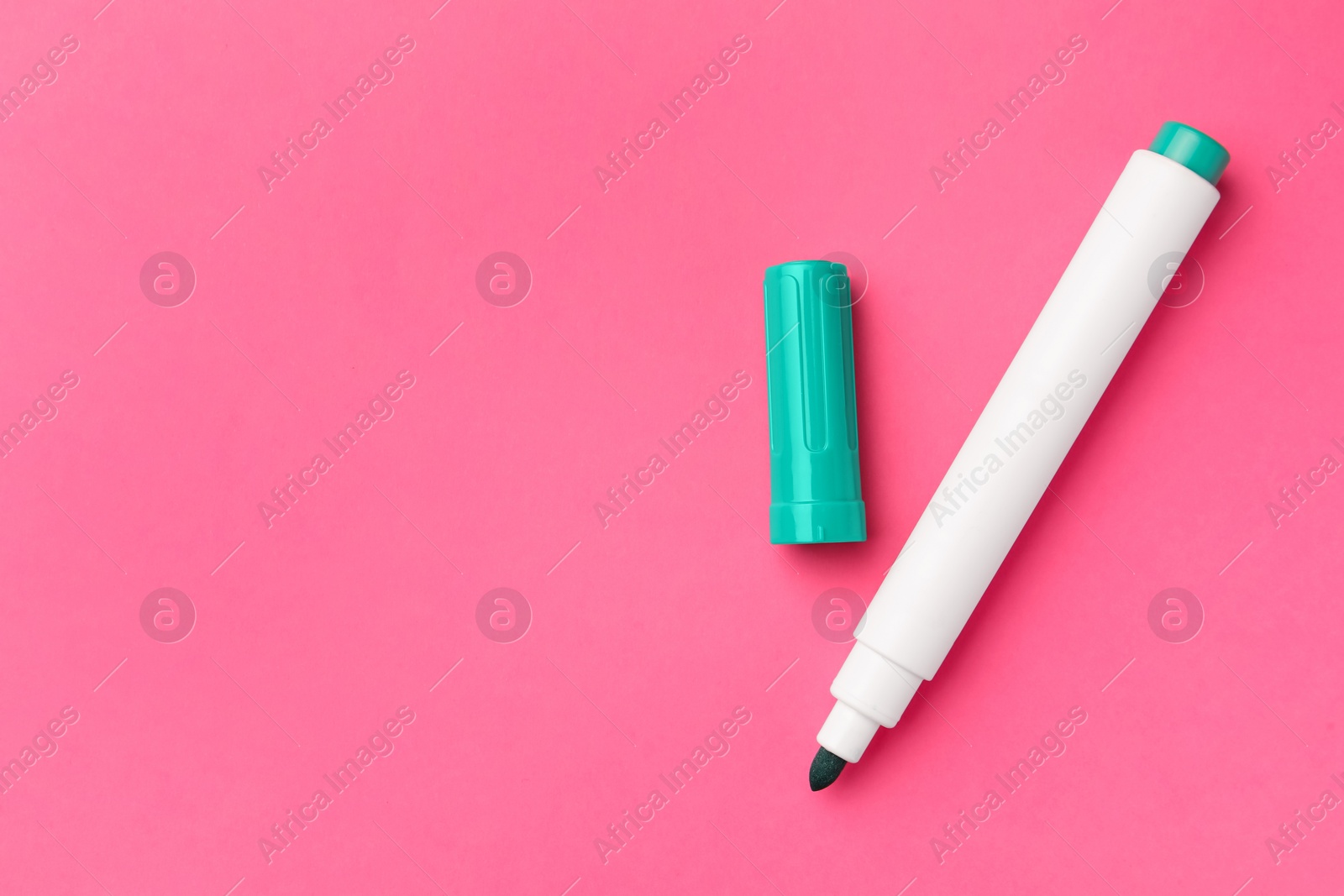 Photo of Bright green marker on pink background, flat lay. Space for text