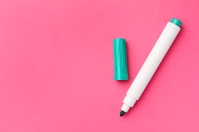 Bright green marker on pink background, flat lay. Space for text