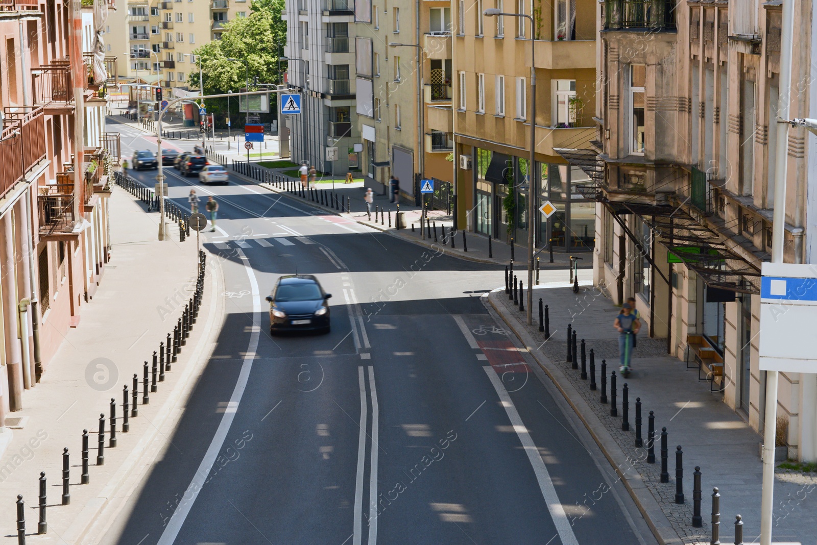 Photo of Beautiful road with cars near buildings in city