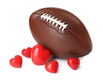 Photo of American football ball and hearts on white background