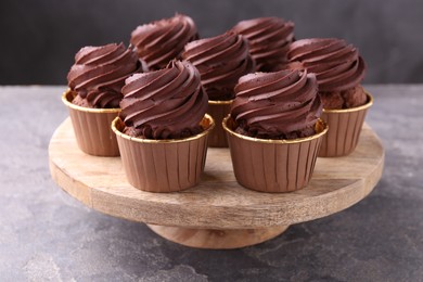 Delicious chocolate cupcakes on grey textured table