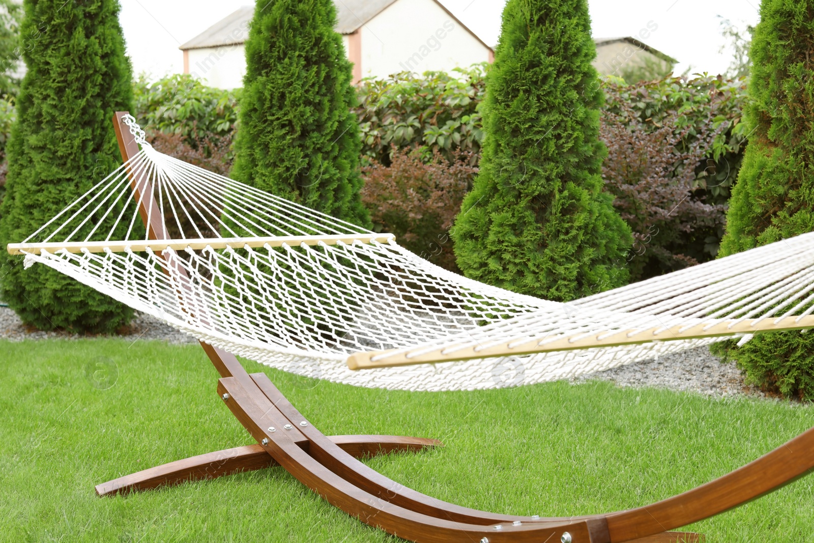 Photo of Empty comfortable hammock outdoors on sunny day