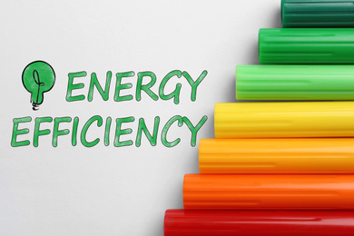Image of Energy efficiency concept. Colorful markers on white background, flat lay