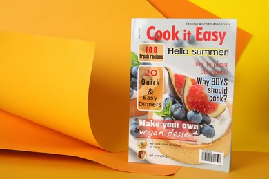 Photo of Modern culinary magazine on bright background. Space for text