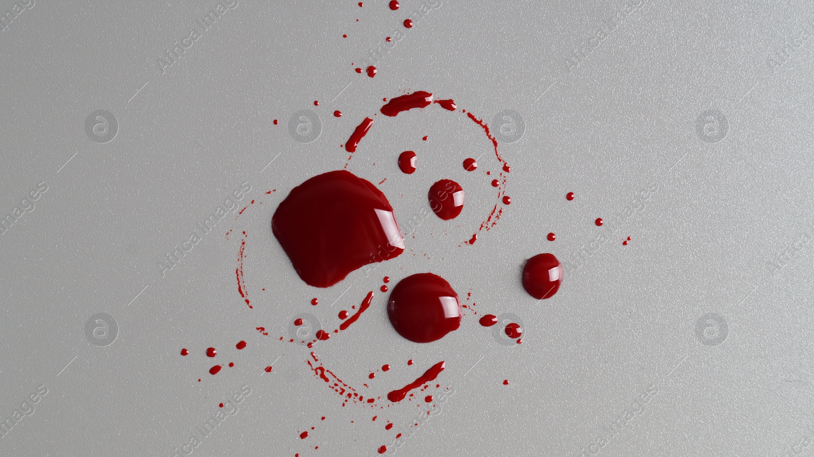 Photo of Stain and splashes of blood on grey background, top view