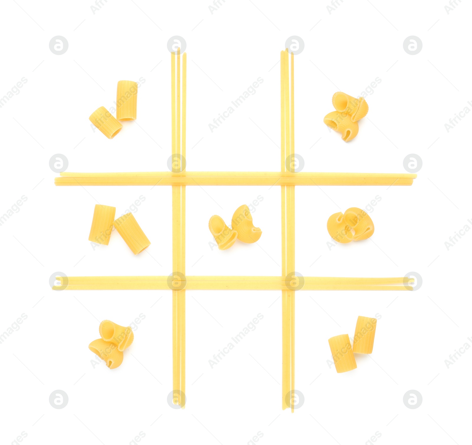 Photo of Tic tac toe game made with different types of pasta isolated on white, top view