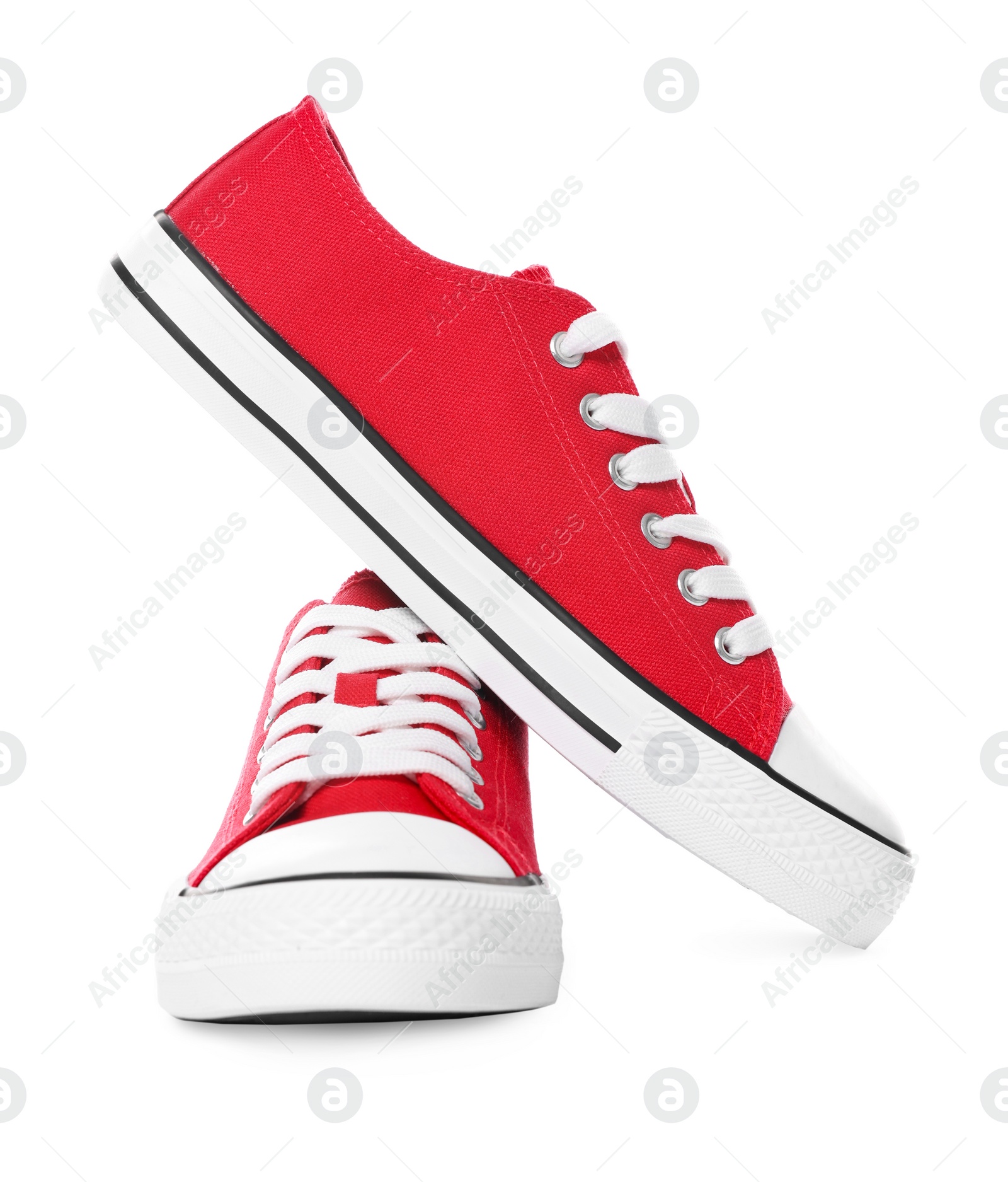 Photo of Pair of red classic old school sneakers on white background