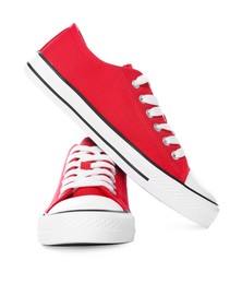 Pair of red classic old school sneakers on white background