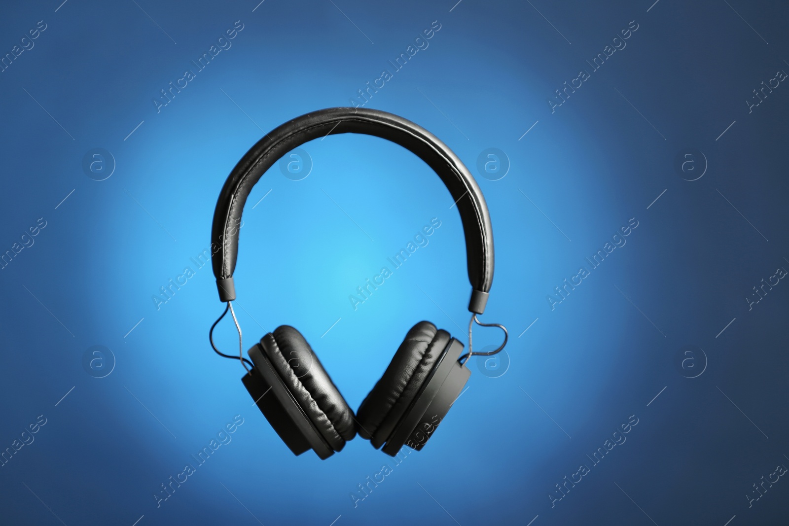 Photo of Stylish headphones on color background. Space for text