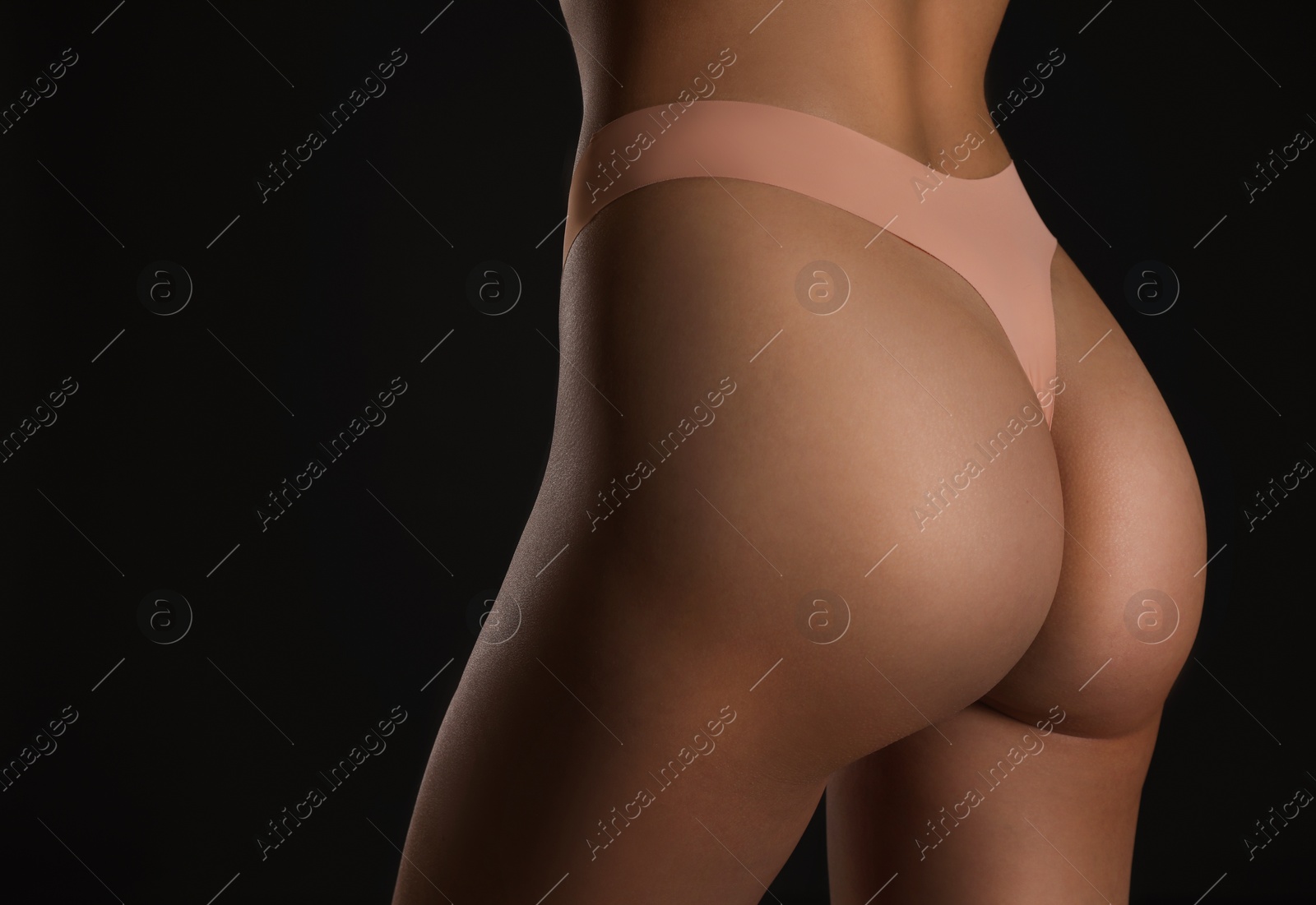 Photo of Closeup view of slim woman in underwear on black background, space for text. Cellulite problem concept