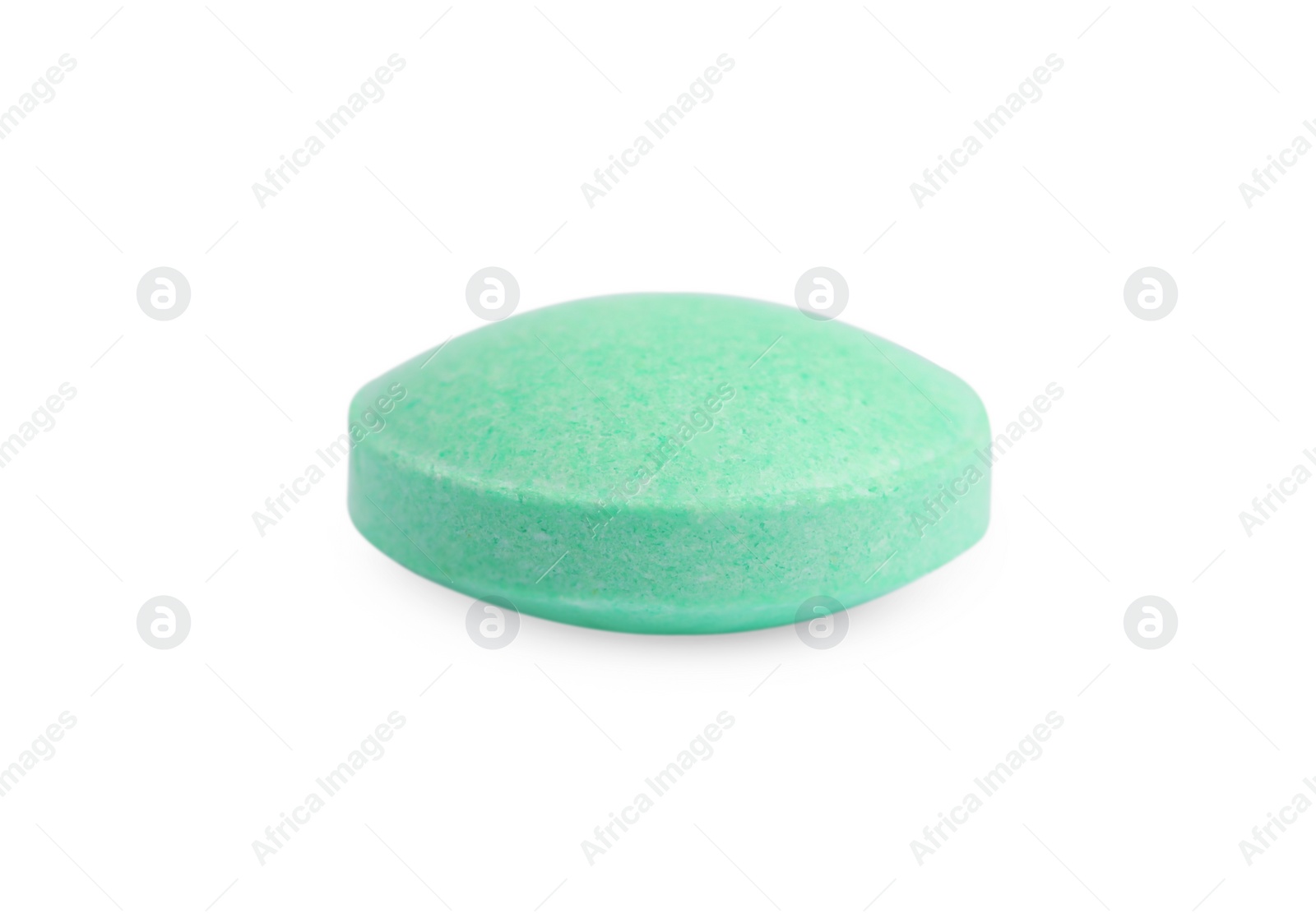 Photo of One light green pill on white background. Medicinal treatment