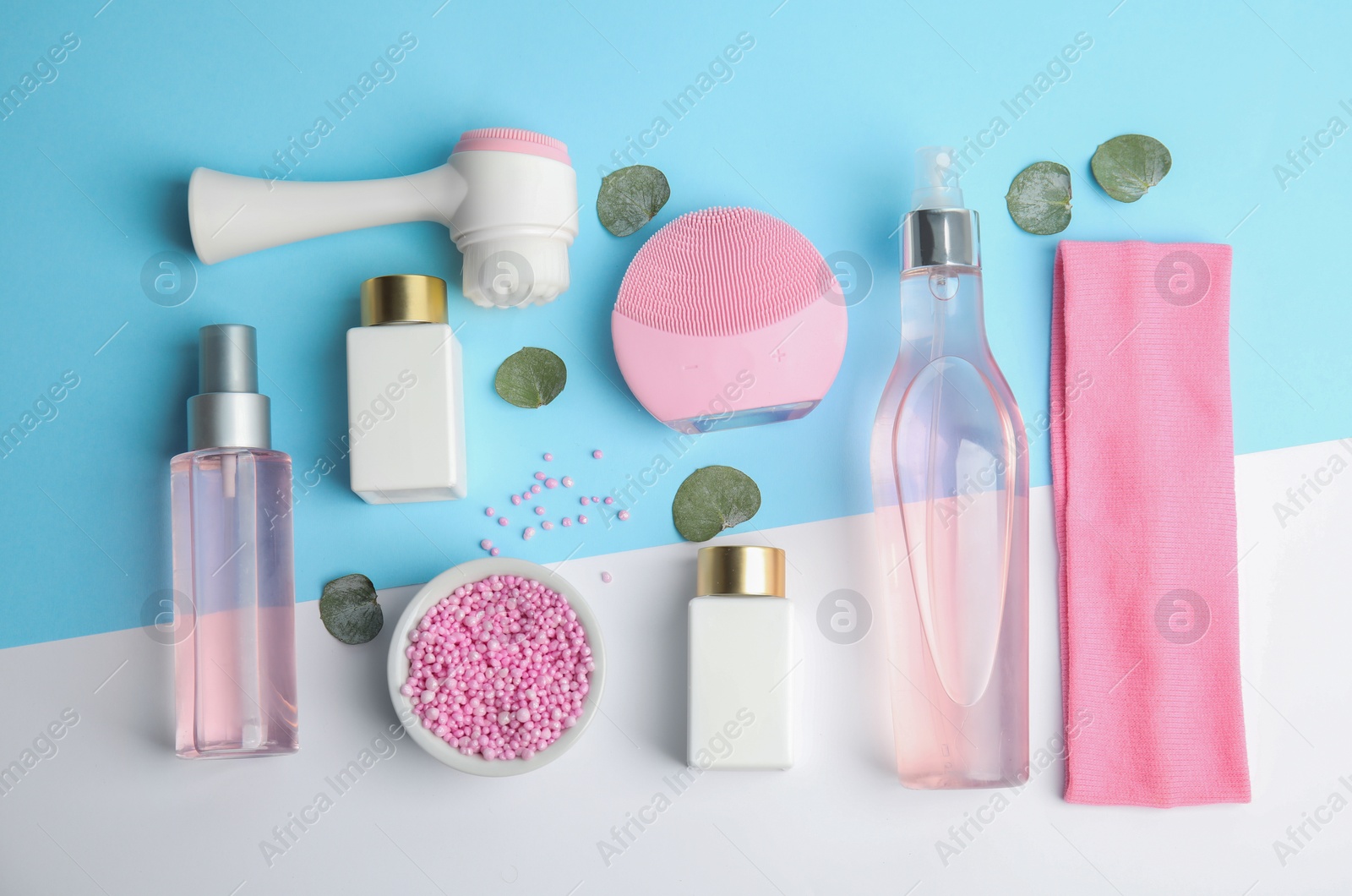 Photo of Flat lay composition with face cleansing brushes on color background. Cosmetic accessories