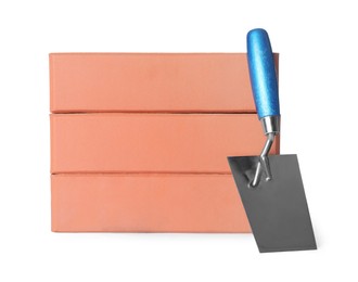 Red bricks and trowel on white background